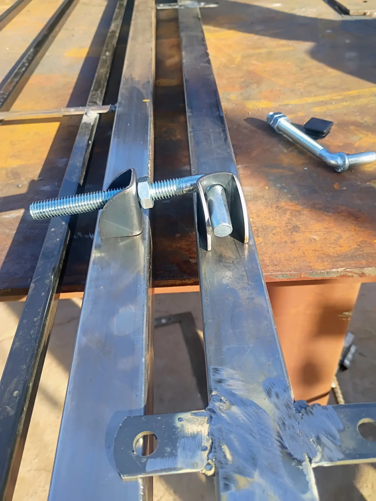 Weld-on adjustable gate hinge on a steel gate frame