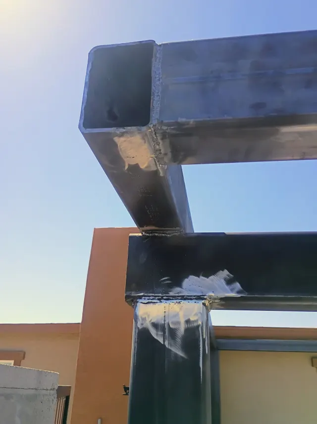 Close-up of full welds at the corner of square steel tube